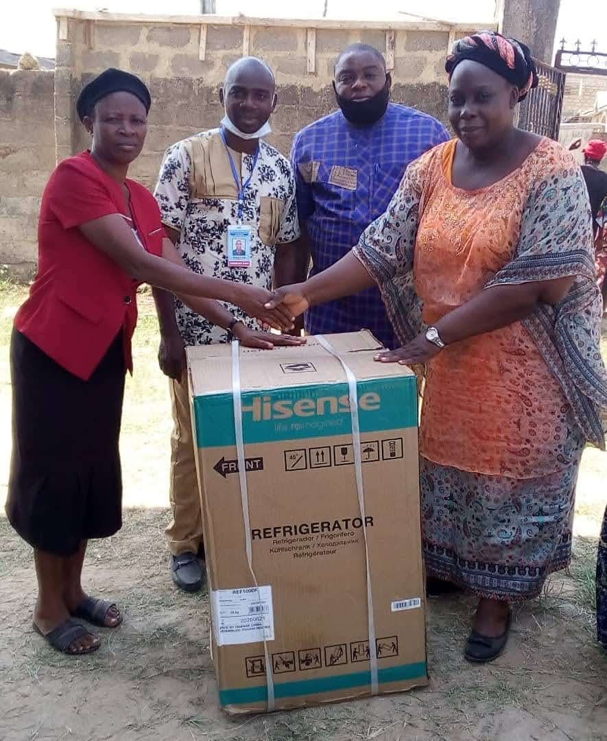 A widow receives a household appliance from the foundation team