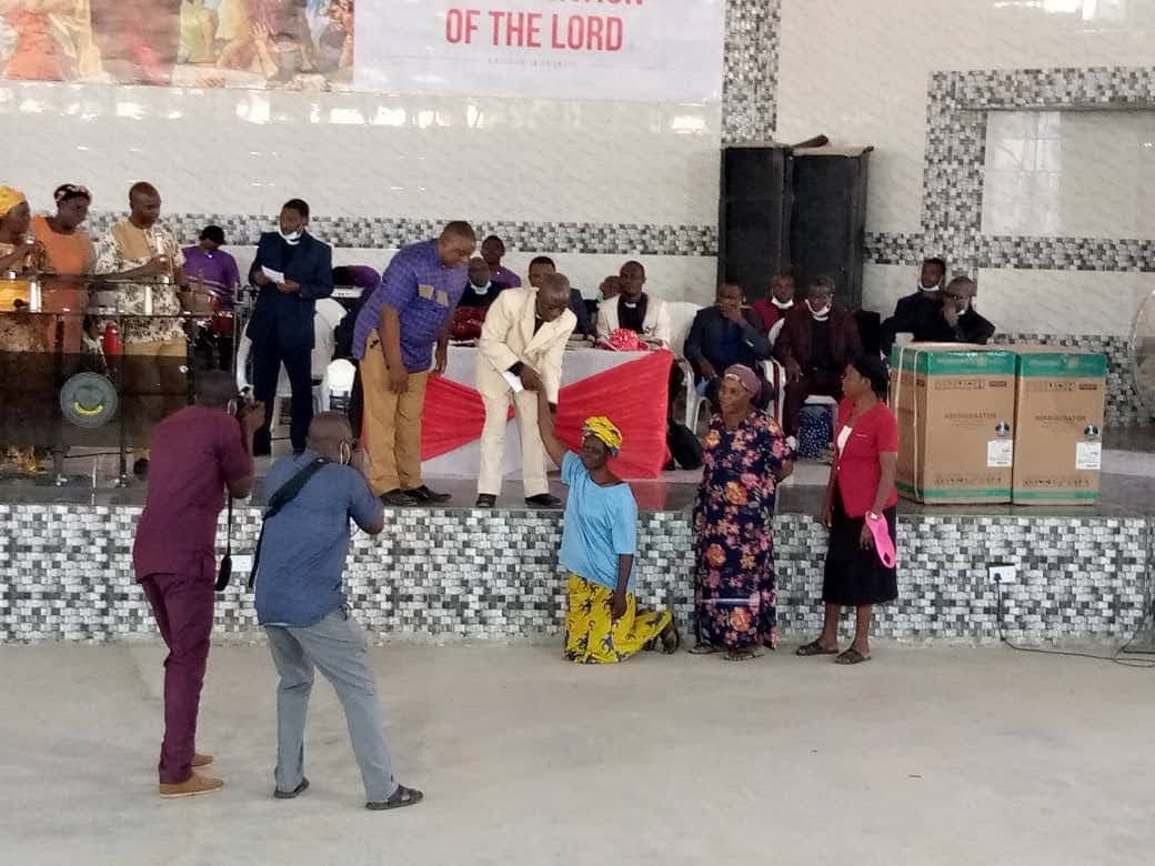 Widow kneeling at the altar during the Sunday gathering